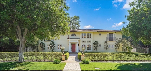 mediterranean / spanish-style home featuring stucco siding and a front yard