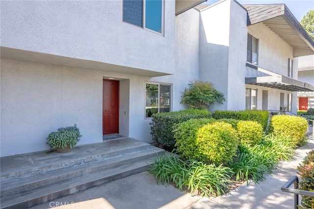 doorway to property with stucco siding