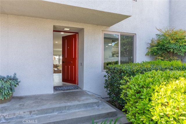 entrance to property featuring stucco siding