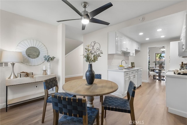 dining space with light wood-style floors, ceiling fan, baseboards, and recessed lighting