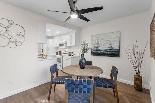 dining area with a ceiling fan, baseboards, wood finished floors, and recessed lighting