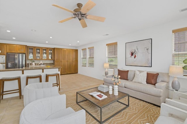 living room featuring ceiling fan, plenty of natural light, light tile patterned flooring, and recessed lighting