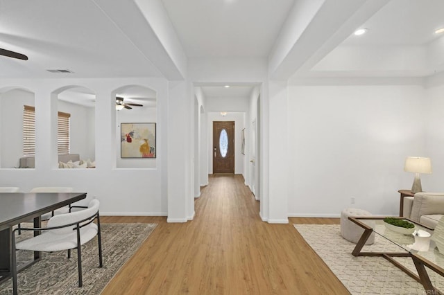 hallway featuring visible vents, baseboards, wood finished floors, and recessed lighting