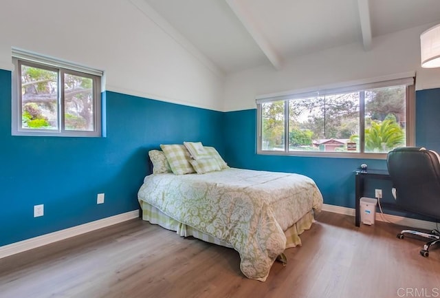 bedroom with lofted ceiling with beams, baseboards, and wood finished floors