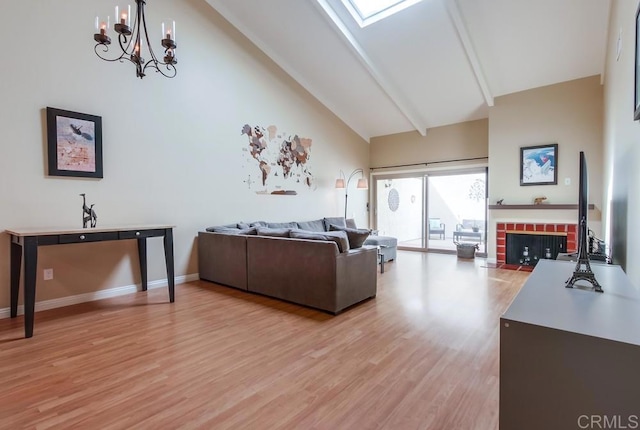 living room with a skylight, light wood finished floors, a fireplace with flush hearth, high vaulted ceiling, and beamed ceiling