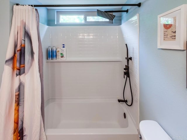 bathroom with shower / bath combo and toilet