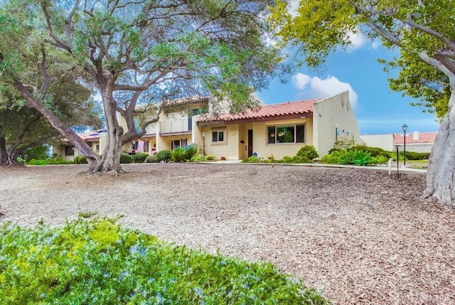 view of front of house with a tile roof and stucco siding