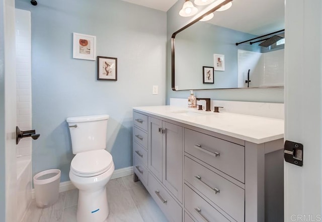 bathroom with vanity, toilet, and baseboards