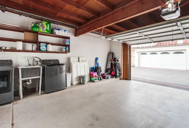 garage featuring washing machine and dryer and a garage door opener