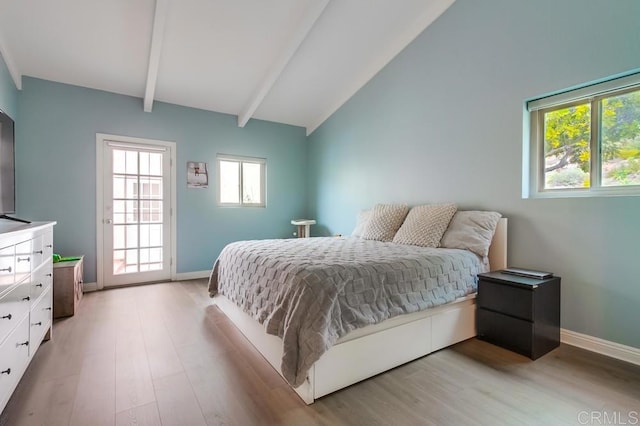 bedroom featuring light wood-type flooring, vaulted ceiling with beams, and baseboards