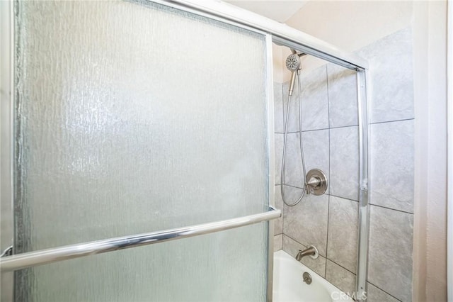 bathroom with combined bath / shower with glass door