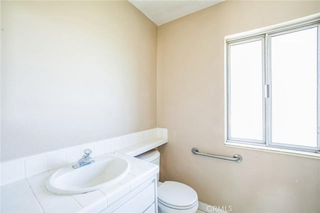 half bath featuring toilet and vanity