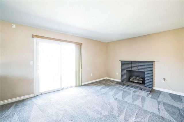 unfurnished living room with carpet, a fireplace, and baseboards