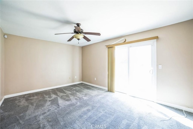 carpeted empty room featuring ceiling fan and baseboards