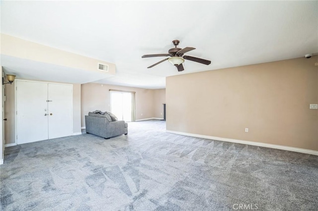 unfurnished room featuring carpet flooring, visible vents, and baseboards