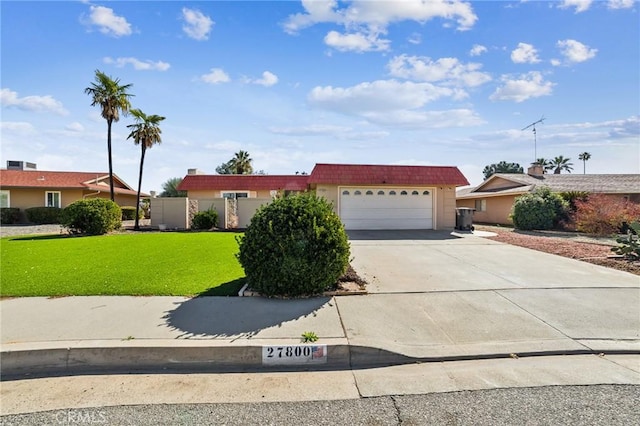 ranch-style house with driveway, a garage, a front lawn, and mansard roof