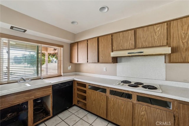 kitchen featuring under cabinet range hood, black dishwasher, light countertops, and a sink