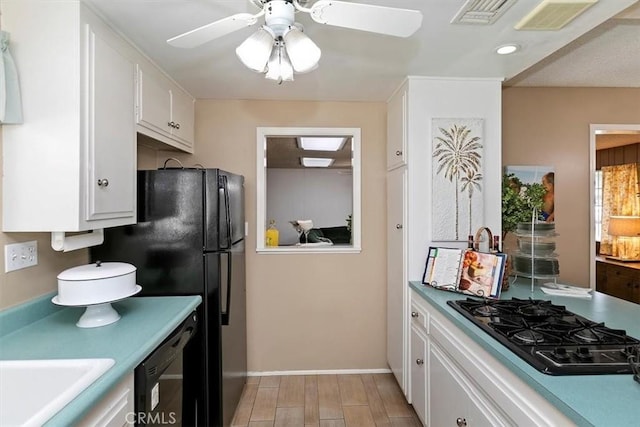 kitchen featuring visible vents, black appliances, ceiling fan, and white cabinetry