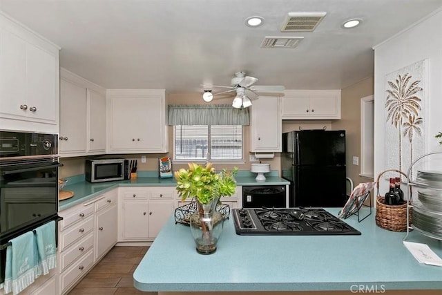 kitchen with visible vents, black appliances, ceiling fan, and white cabinets