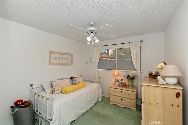 bedroom featuring ceiling fan, carpet flooring, and a textured ceiling