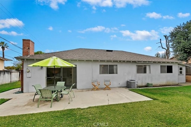 rear view of house featuring a yard, a patio area, fence, and stucco siding