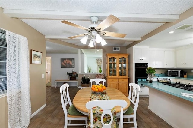 dining area with visible vents, baseboards, ceiling fan, wood tiled floor, and beam ceiling