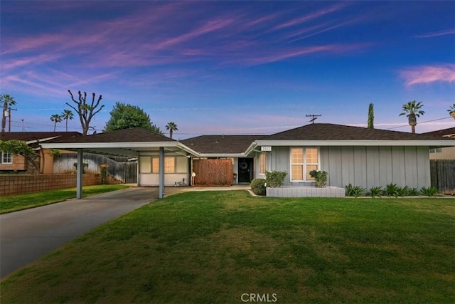 ranch-style home with fence, a yard, a carport, concrete driveway, and a garage