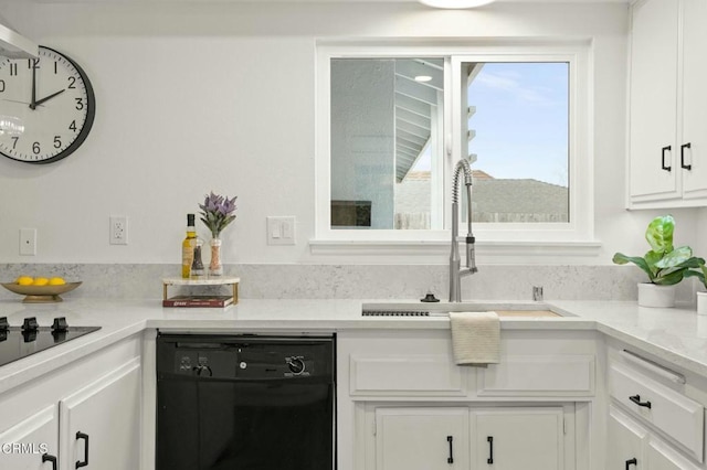 kitchen featuring white cabinetry, black appliances, light countertops, and a sink