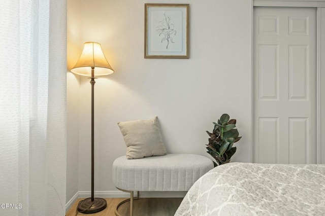 bedroom with baseboards and wood finished floors