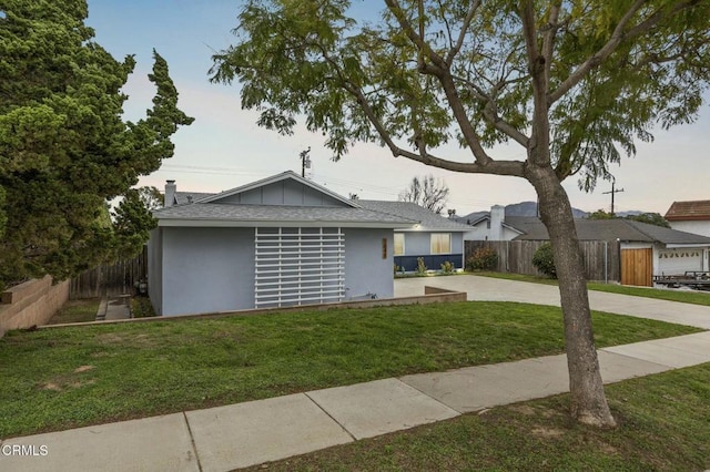 single story home with a patio area, stucco siding, a front lawn, and fence