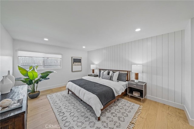 bedroom with baseboards, wood finished floors, and recessed lighting