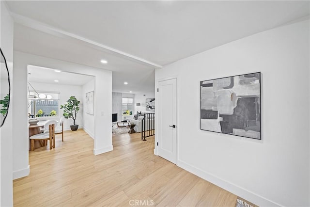 interior space with baseboards, recessed lighting, and light wood-style floors