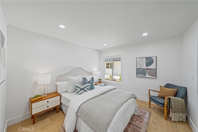 bedroom featuring light wood-style floors, recessed lighting, and baseboards