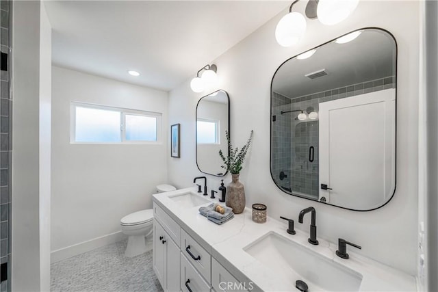 full bathroom featuring toilet, a sink, visible vents, and a shower stall