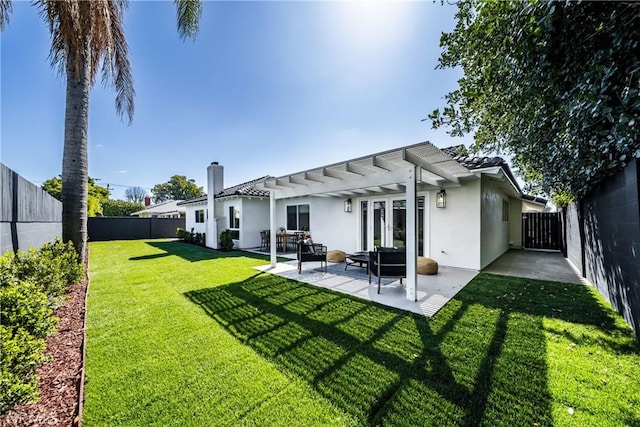 rear view of house featuring a patio, a yard, a fenced backyard, and stucco siding