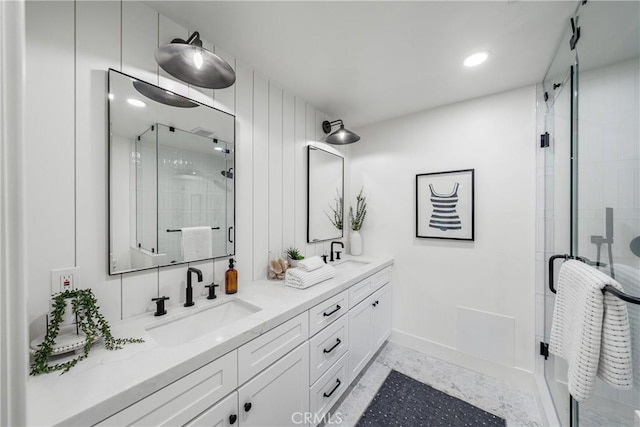 full bath featuring a stall shower, a sink, and double vanity