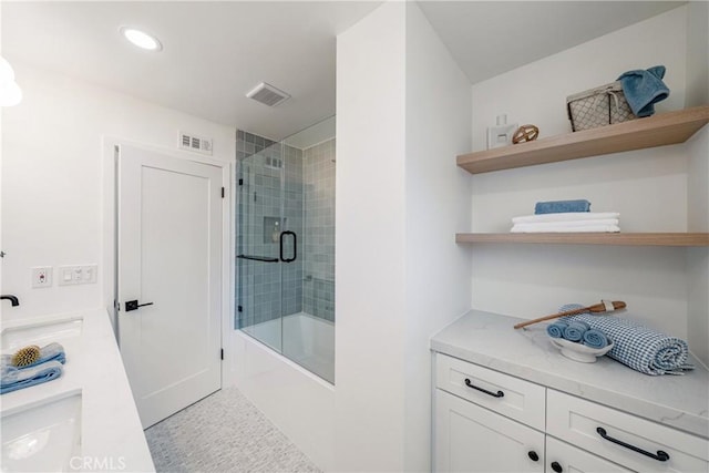 full bathroom with shower / bath combination with glass door, visible vents, and vanity