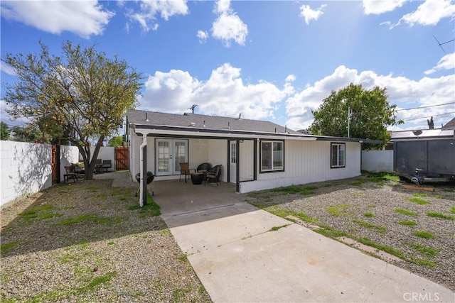 back of house with french doors, a fenced backyard, and a patio