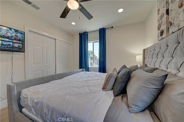 bedroom featuring recessed lighting, wood finished floors, visible vents, a ceiling fan, and a closet