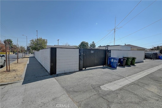 garage featuring fence and a gate