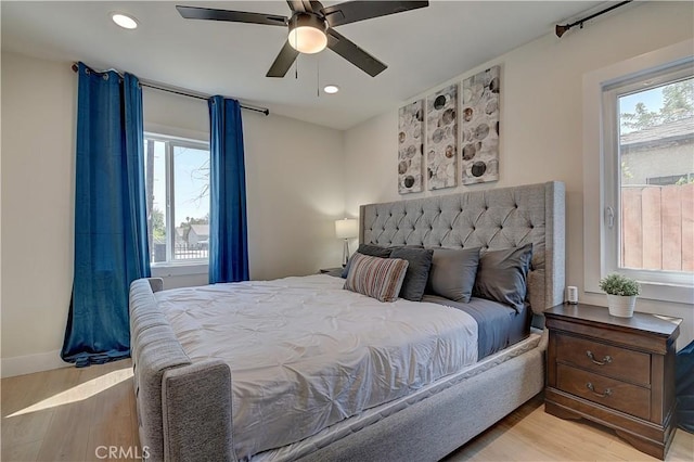 bedroom with light wood finished floors, ceiling fan, baseboards, and recessed lighting