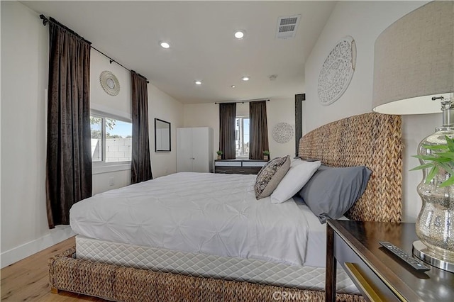 bedroom featuring recessed lighting, visible vents, multiple windows, and wood finished floors