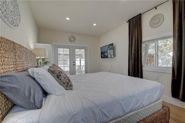 bedroom with access to exterior, recessed lighting, french doors, and wood finished floors