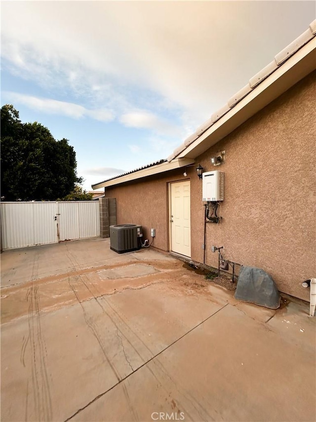 view of patio with a gate and central AC