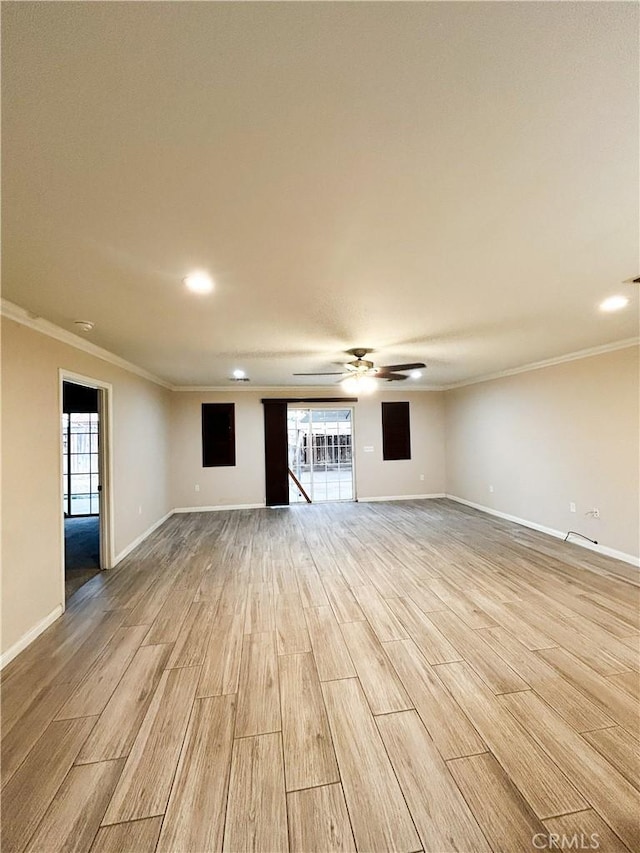 unfurnished living room with baseboards, light wood finished floors, a ceiling fan, and crown molding