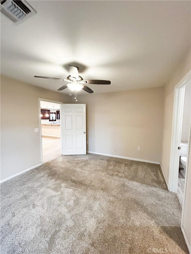 unfurnished bedroom with ceiling fan, carpet flooring, visible vents, and baseboards