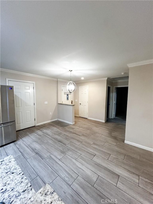 interior space featuring a chandelier, ornamental molding, baseboards, and wood tiled floor