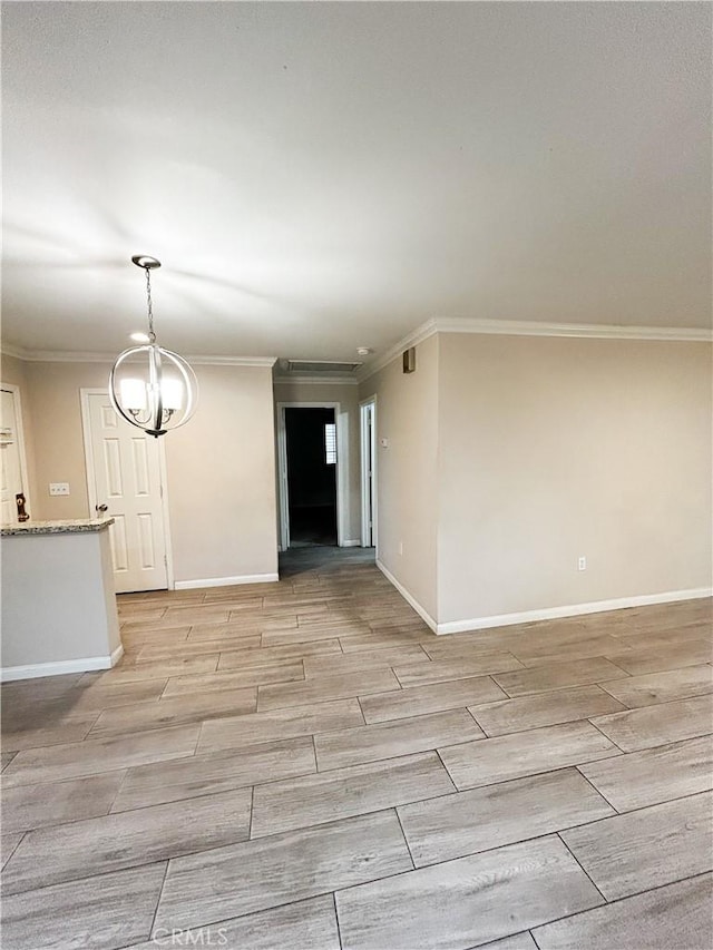 unfurnished room featuring baseboards, ornamental molding, and wood tiled floor