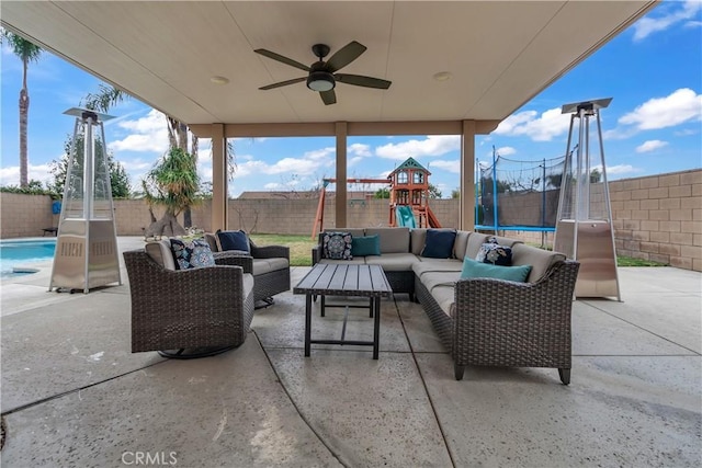 view of patio / terrace featuring an outdoor living space, a playground, a trampoline, and a fenced backyard