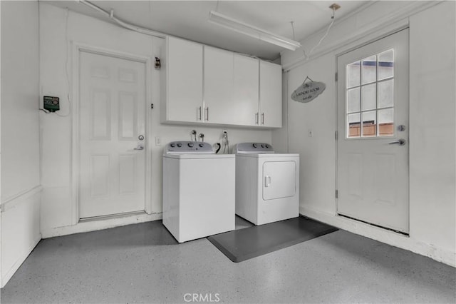 clothes washing area with cabinet space and independent washer and dryer